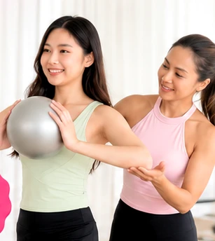 Pilates instructor guiding a member through a private session