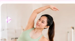 Woman doing a guided Pilates stretch